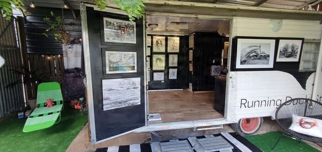 caravan repurposed as a gallery space for black and white artwork