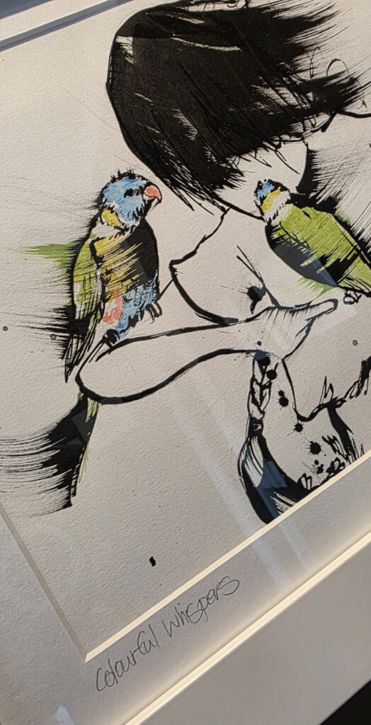 Colourful Whispers: ink illustration of a woman with two green and blue watercolour parrots perched on her hands.