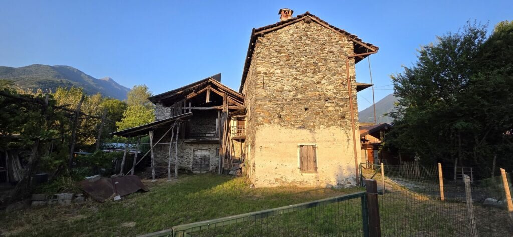 Old stone barn in Piantedo glowing in golden evening light