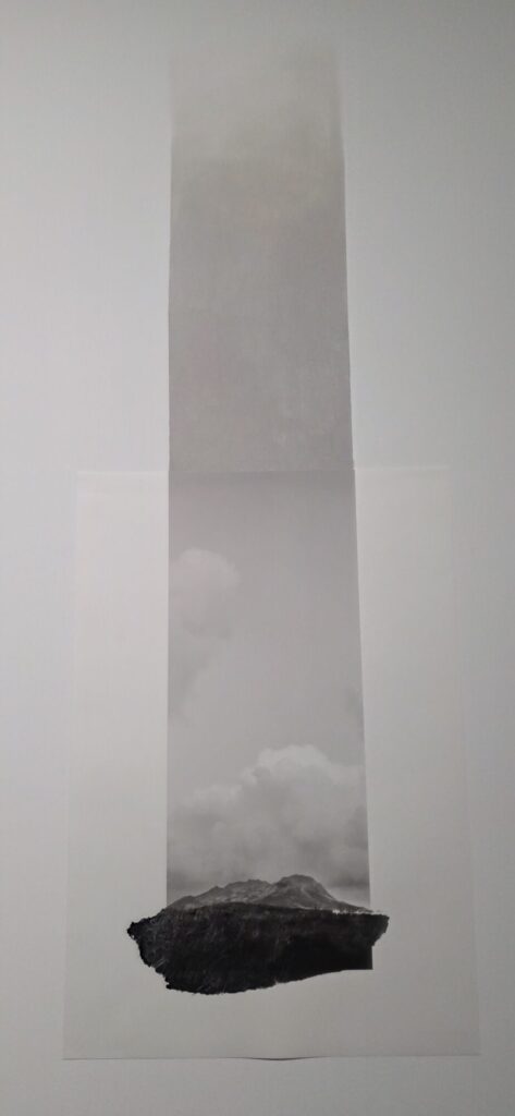 Dana Cojbuc work at the Drawing Lab Paris, a dark jagged charcoal mountain form rising out of a black and white photographic strip of clouds on pale paper